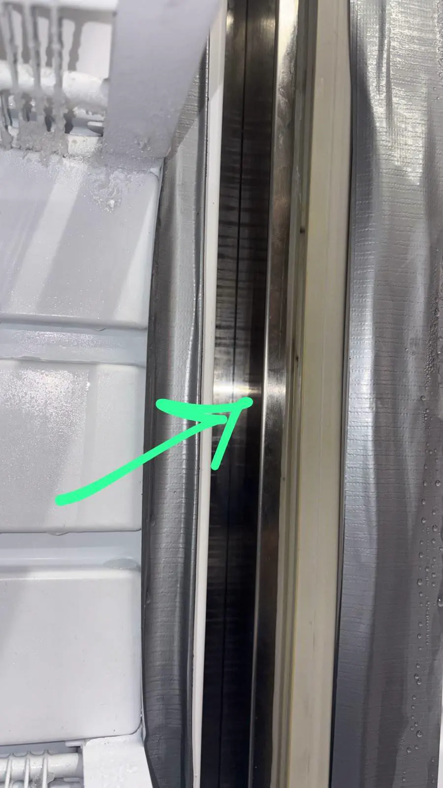 Close-up comparing the flexible door seal with the rigid cabinet edge