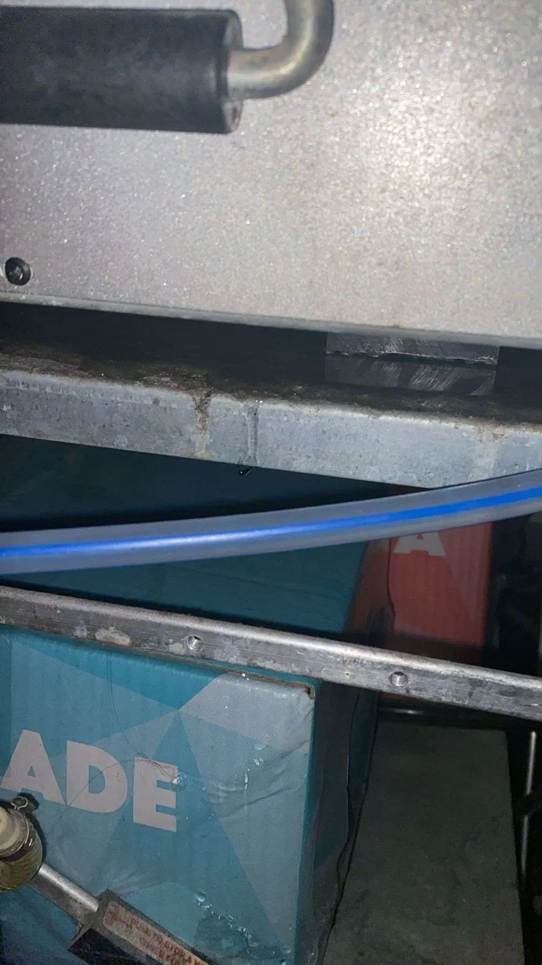 Close-up of leaking waste or overflow area on postmix machine