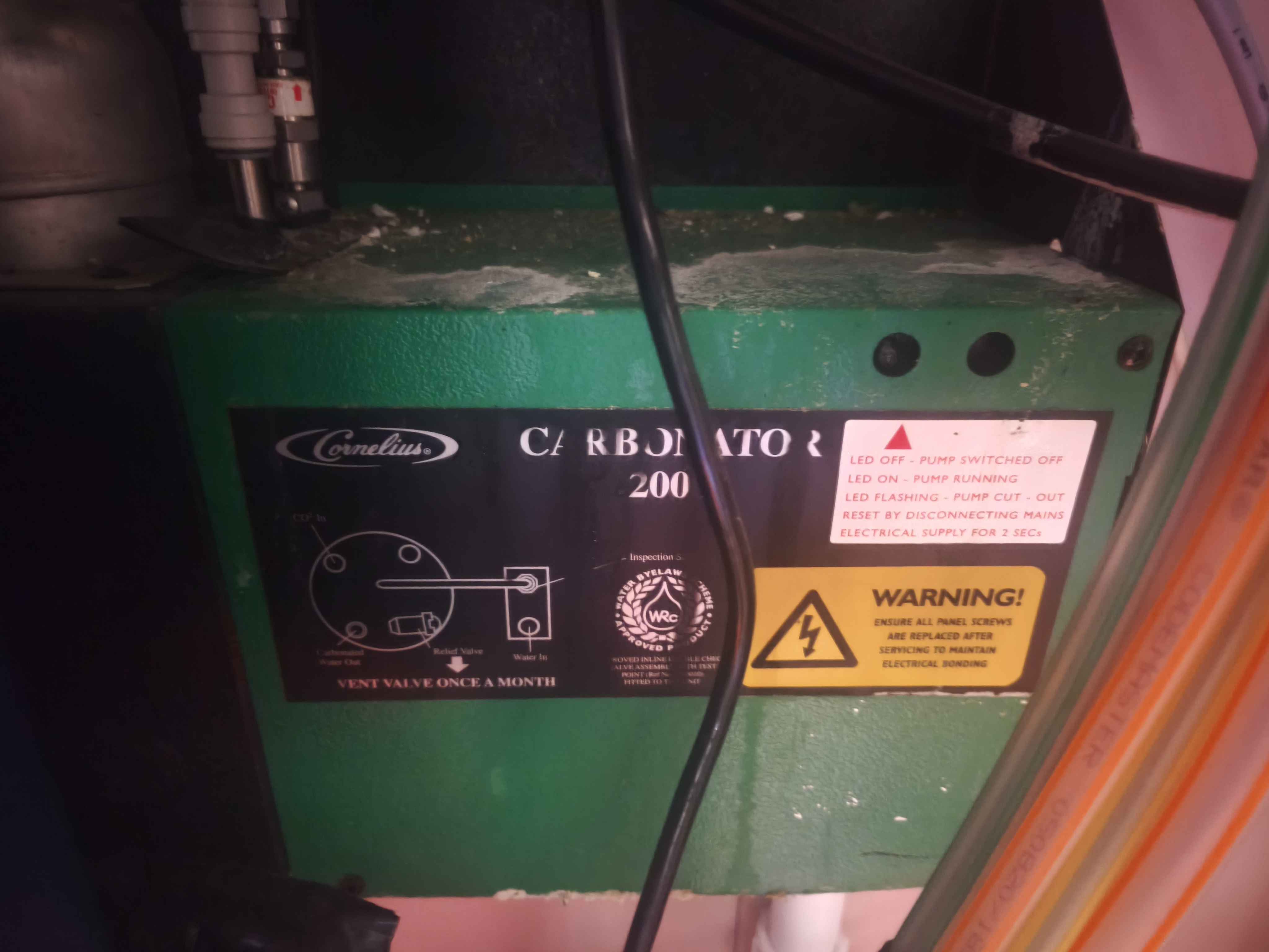 Cornelius carbonator label showing 200-series marking and pump warning