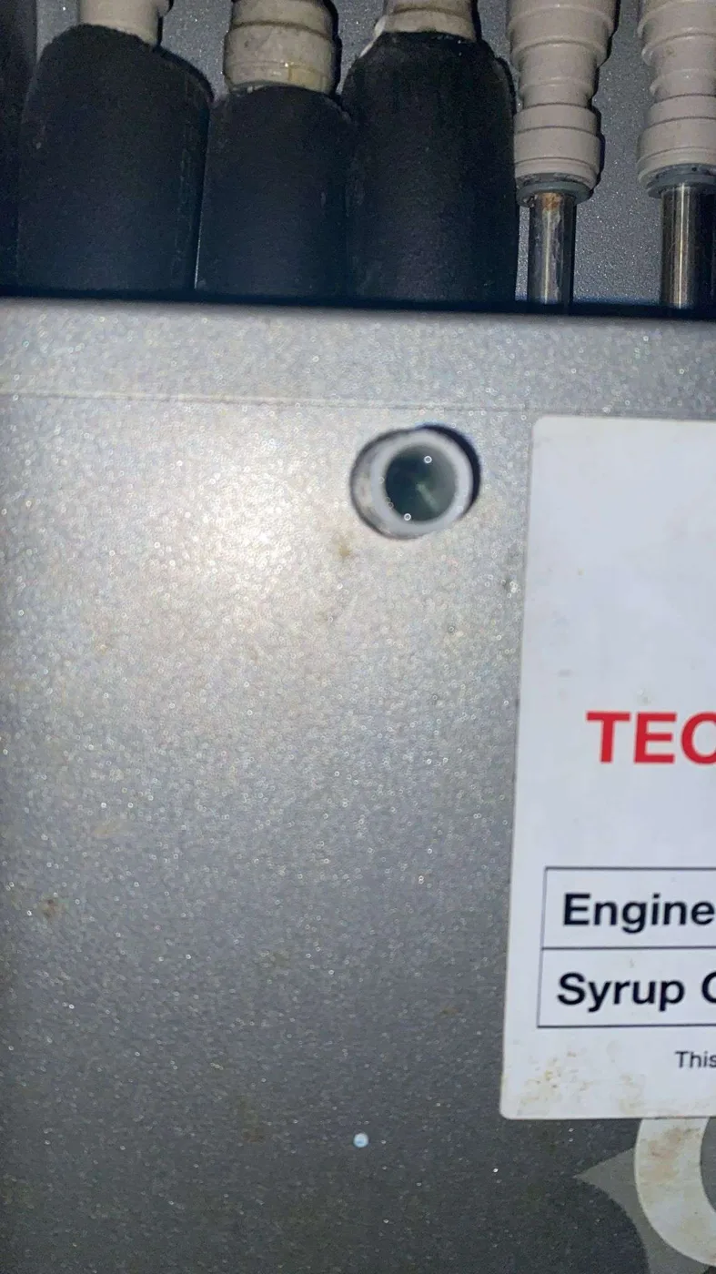 Waste or overflow port visible on Optima 7 postmix unit